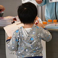 A boy holding a stamp rally card