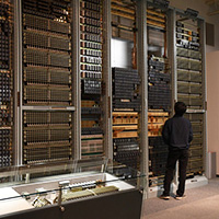 Visitor looking up a switching system exhibit